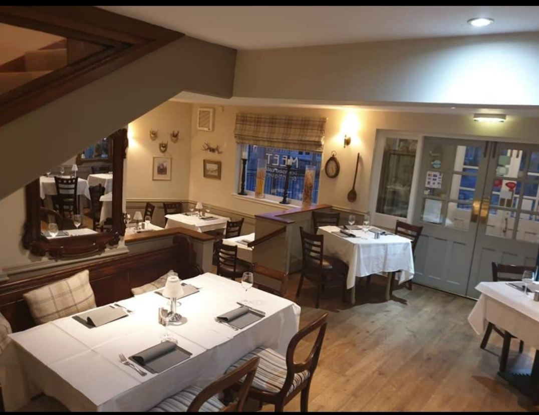 The dining room, laid with white tablecloths