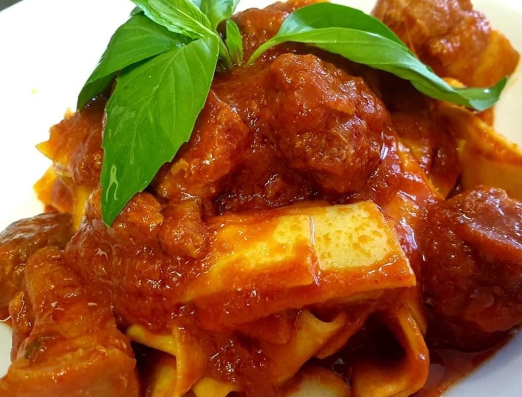 Pappardelle in a rich tomato ragù with fresh basil