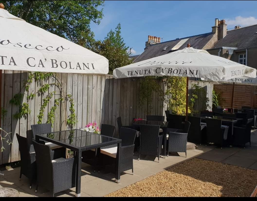 The sheltered terrace with parasols and outdoor seating